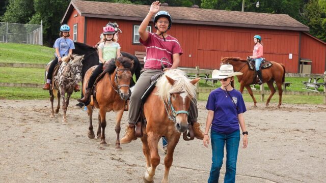 Campers riding horses