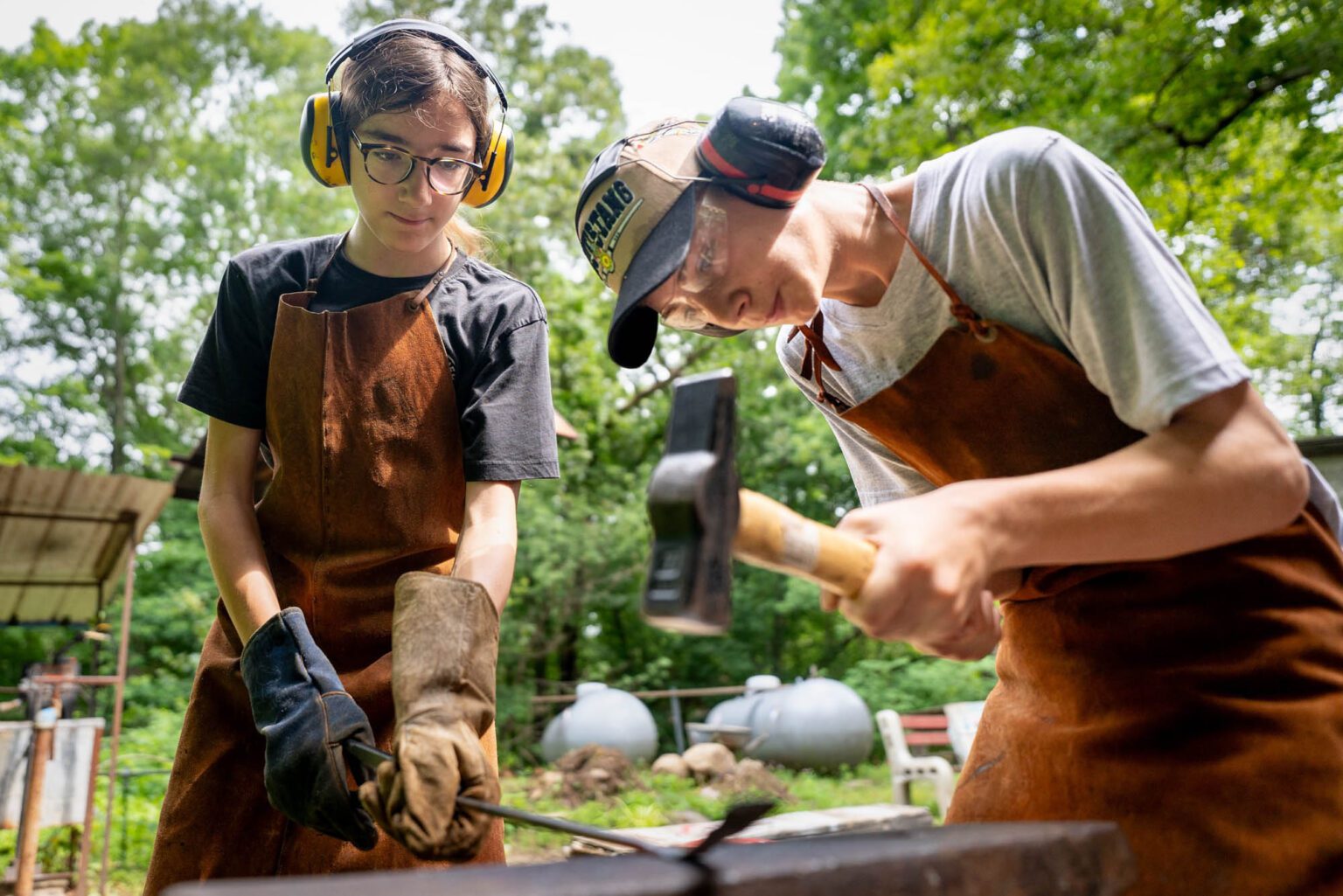 Campers blacksmithing