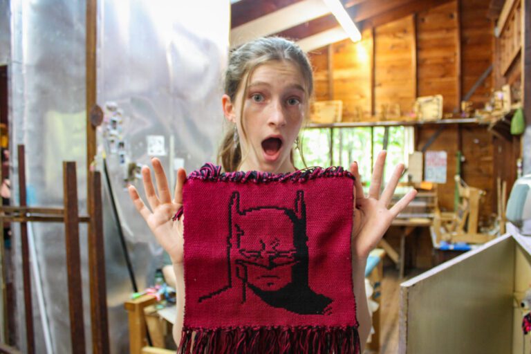 Girl holding sewing project