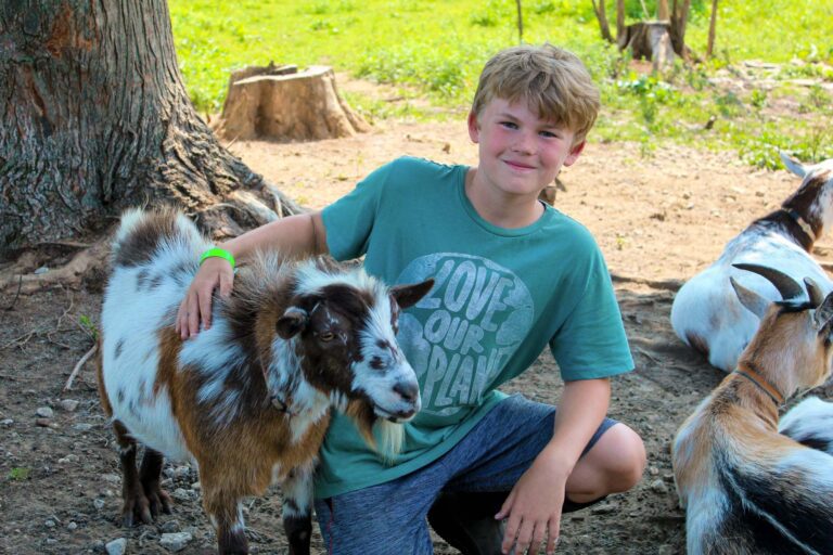 Boy next to goat