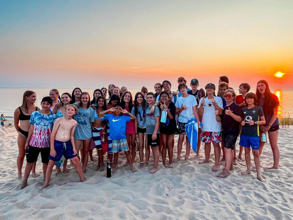 Group of teens at the beach during sunset