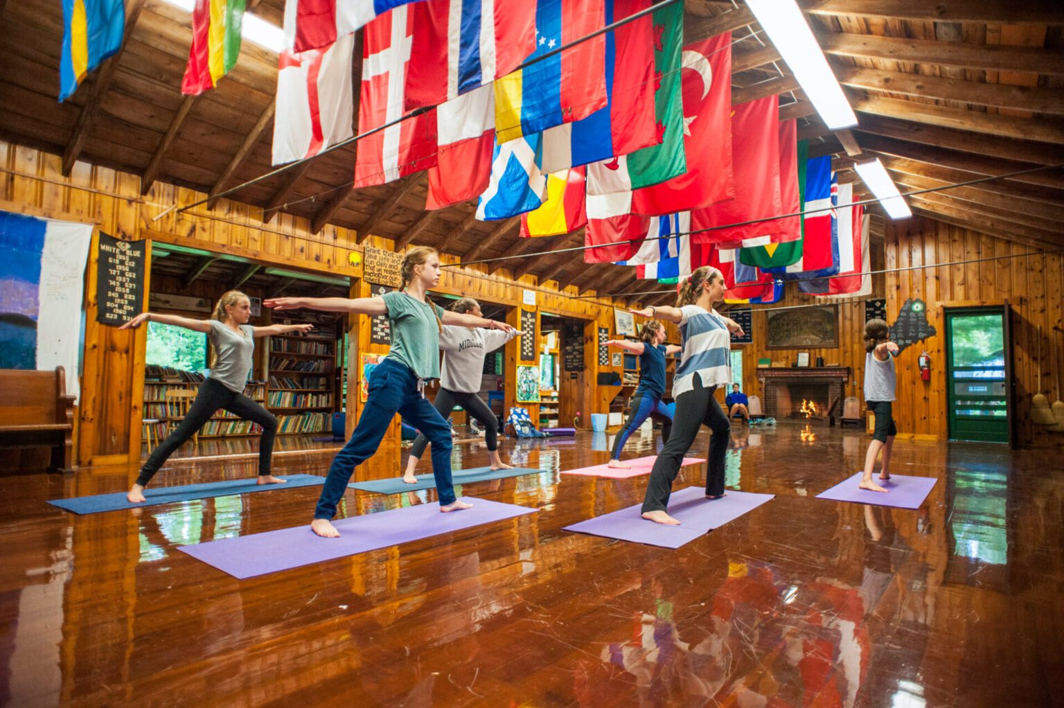 Girls doing yoga in rustic cabin