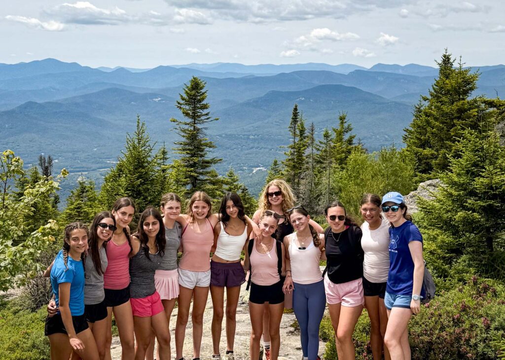 Girls on top of a mountain