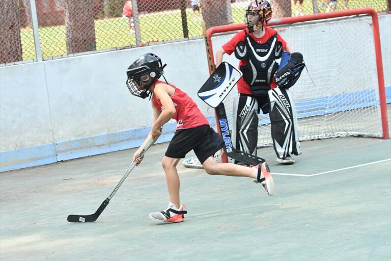 Campers playing street hockey