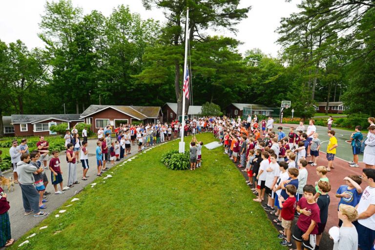 Campers lowering the flag