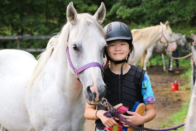 Girl next to horse