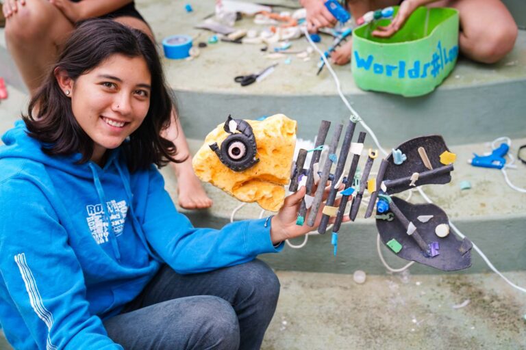 Girl holding art made from beach trash