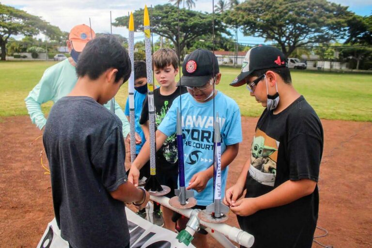Boys preparing model rockets