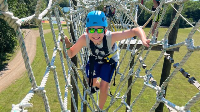 Boy on high ropes course