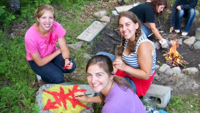 Girls hanging by camp fire