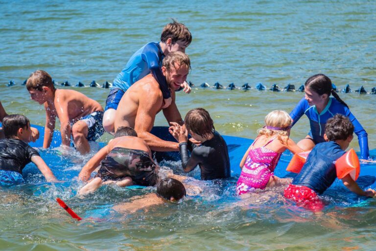 Campers playing on water mat