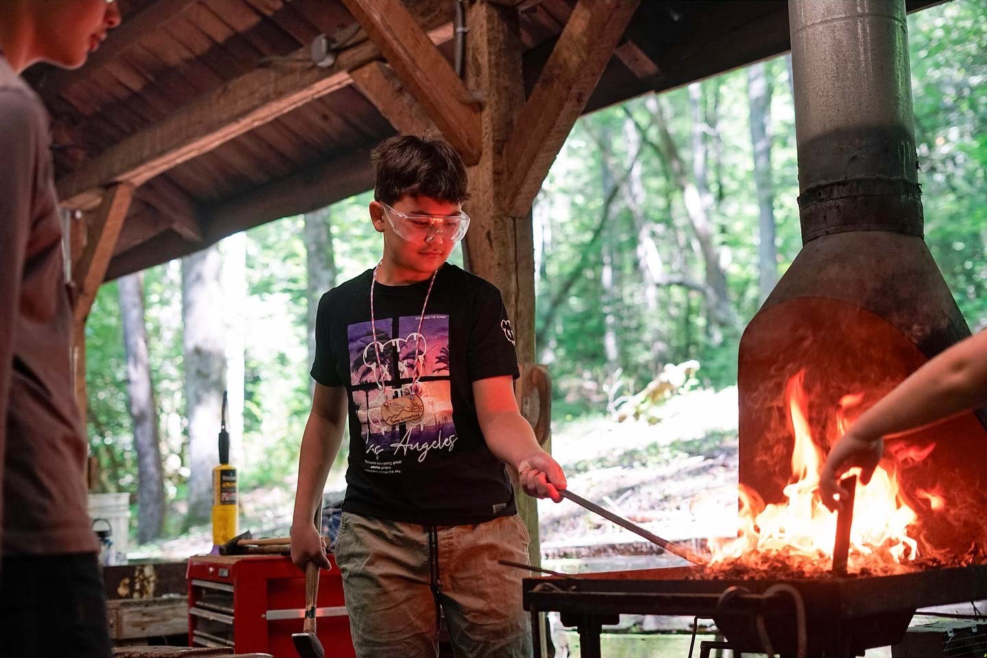 Boy blacksmithing