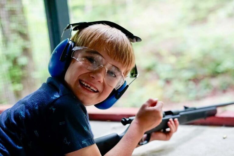 Joyful boy at riflery range