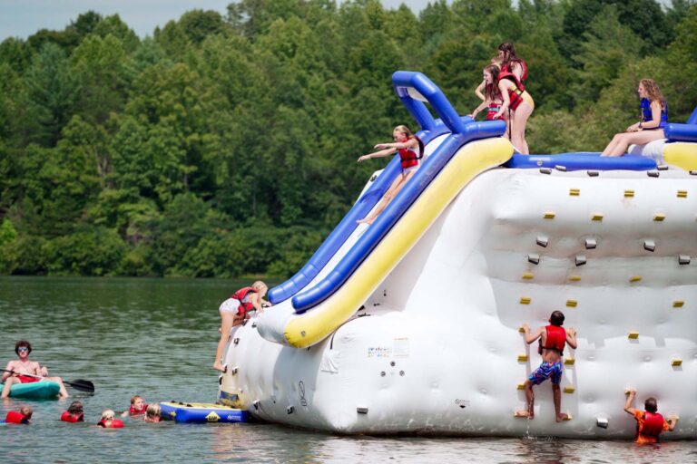 Campers on giant lake inflatable slide