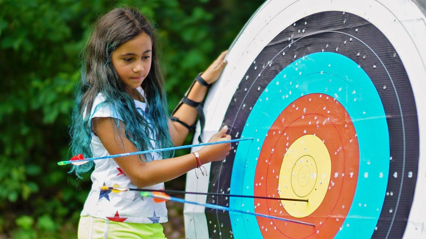 Girl by archery target