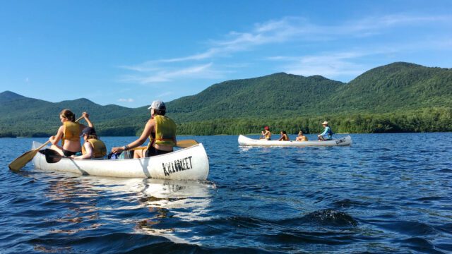 Group canoeing on lake