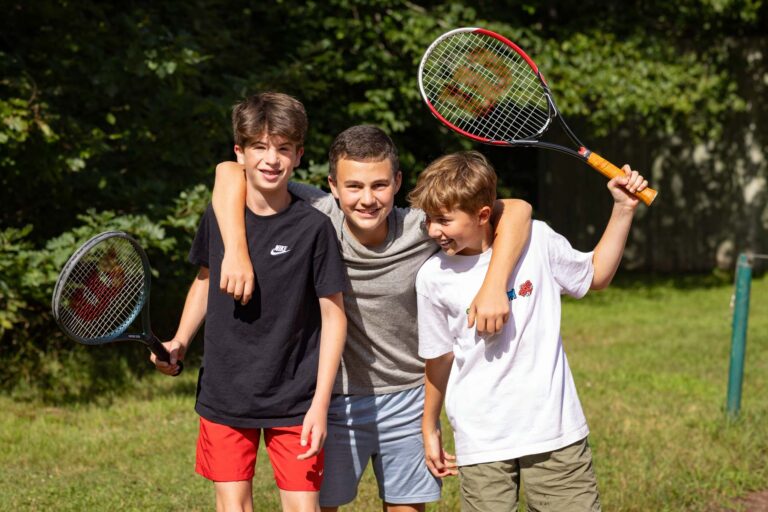 Boys holding tennis rackets