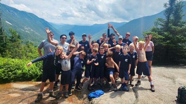 Boys on top of a mountain