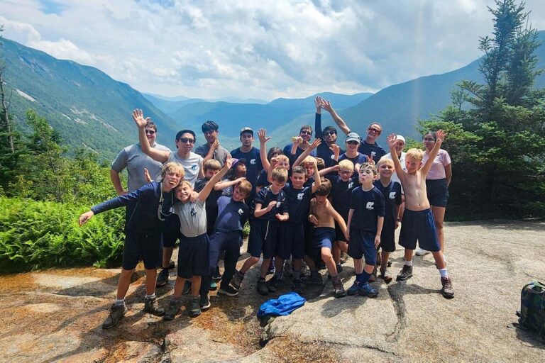 Boys on top of a mountain