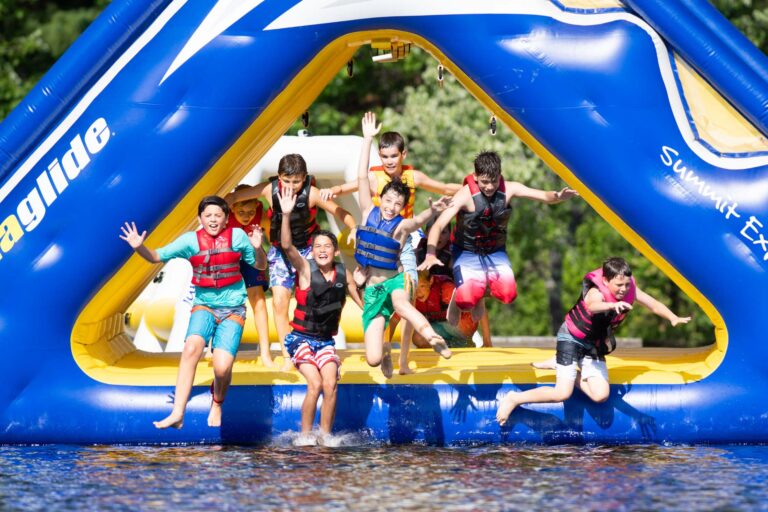 Boys jumping off water inflatable