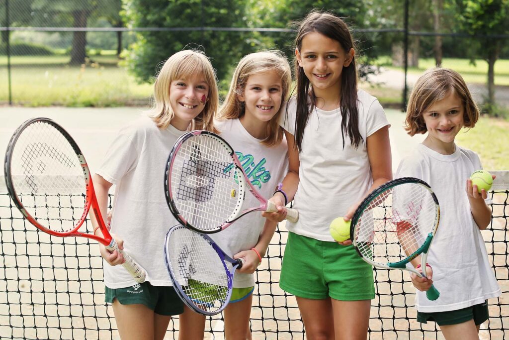 Happy girls playing tennis