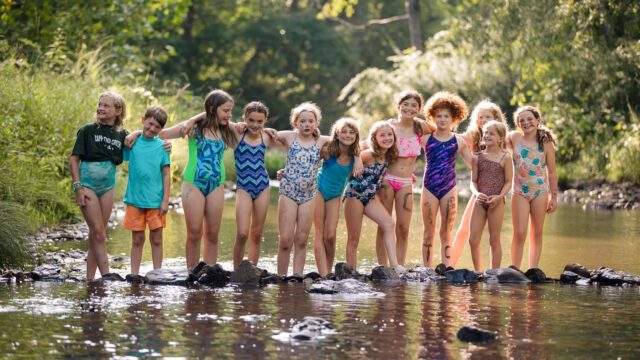 Campers playing in a creek