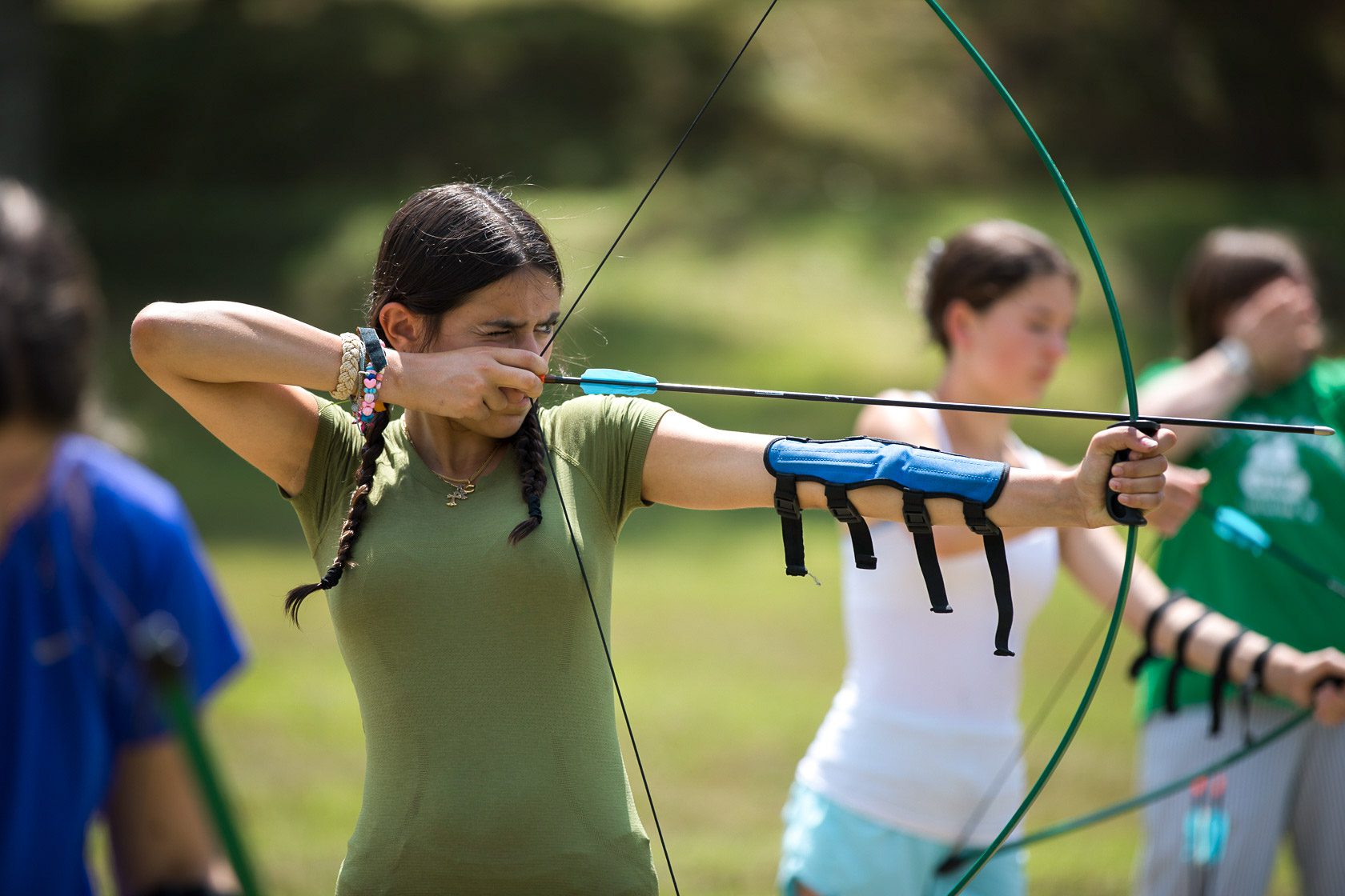 Girl shooting archery bow