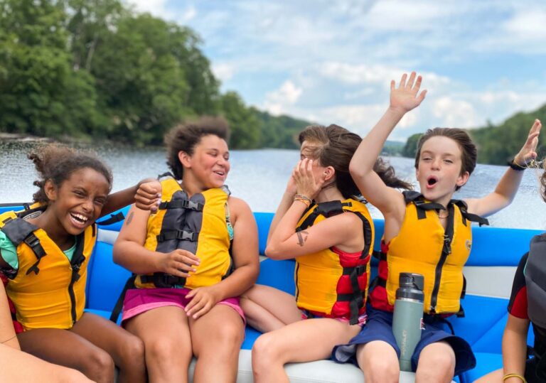 Excited campers in speedboat