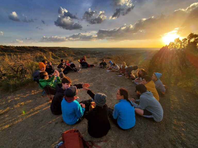 Group enjoying sunset on mountain top