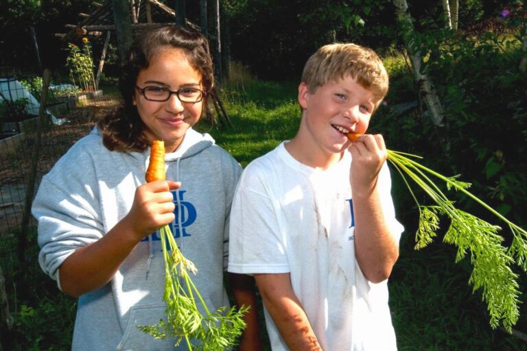 Two campers with carrots