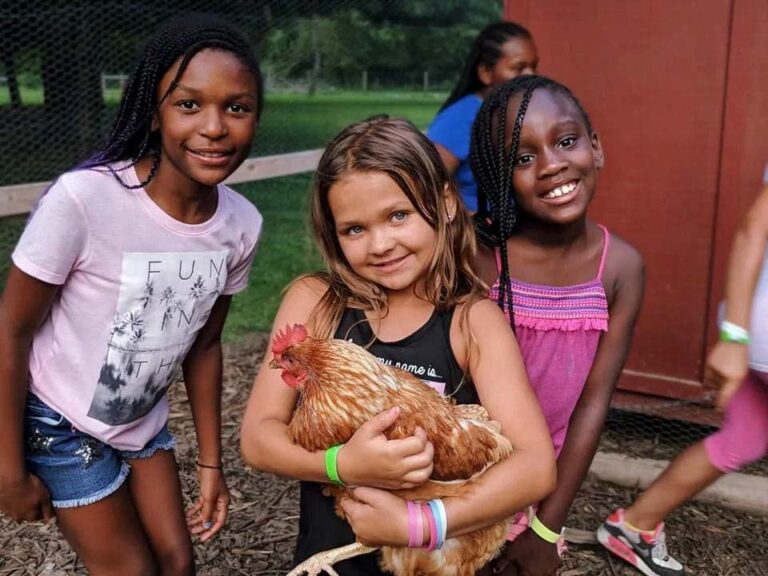 Camper holding a chicken