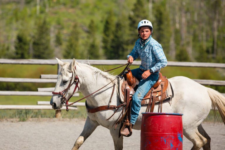 Teen boy riding a horse