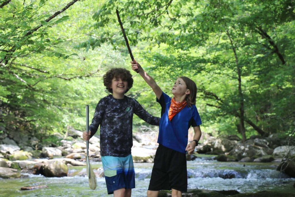 Boys standing in a creek