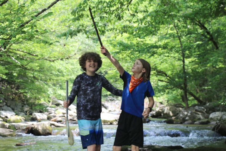 Boys standing in a creek