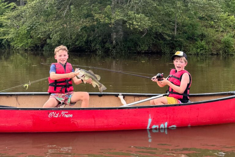 Boys fishing in a canoe