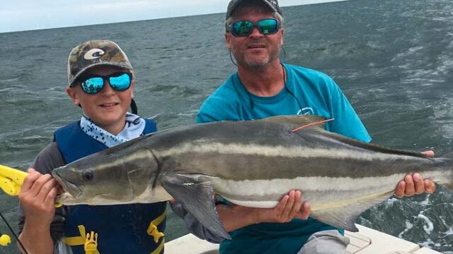 Boy holding large fish