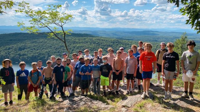 Boys on top of a mountain