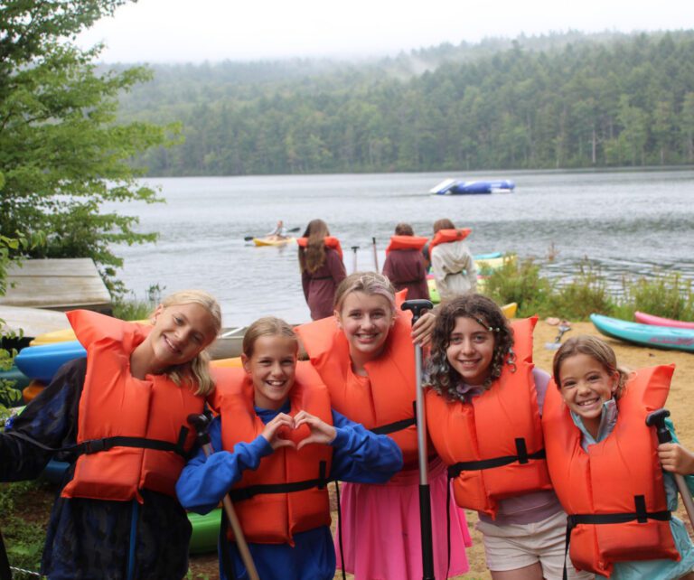 Joyful girls wearing lifejackets
