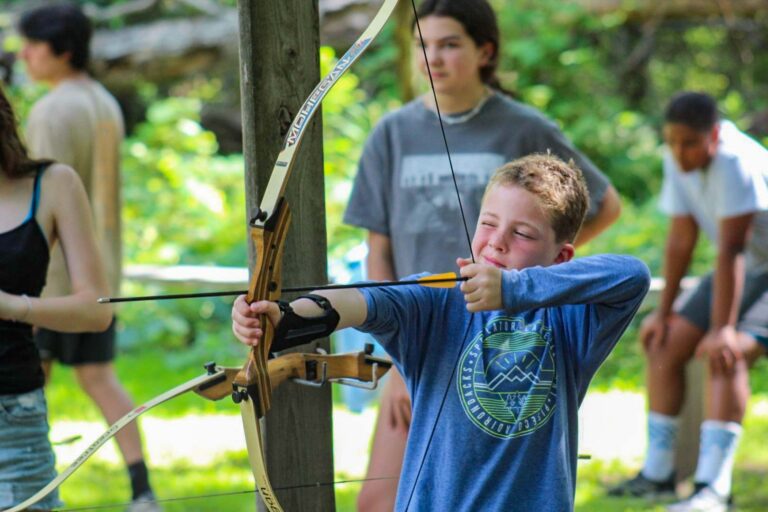 Boy aiming with archery bow