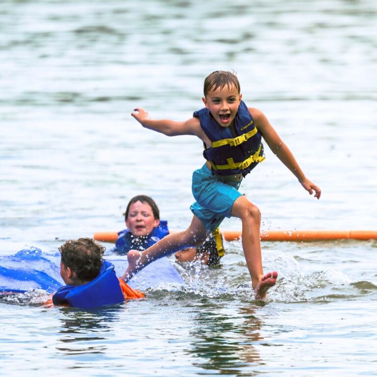 Excited boys playing in the lake