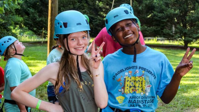 Two campers wearing climbing gear