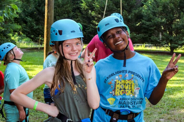 Two campers wearing climbing gear