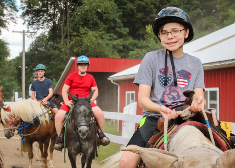 Campers riding horses