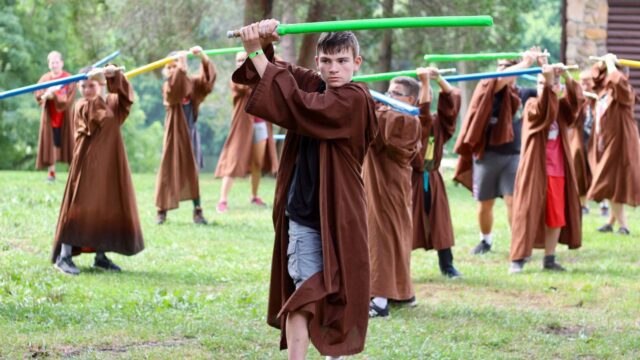 Campers holding light sabers