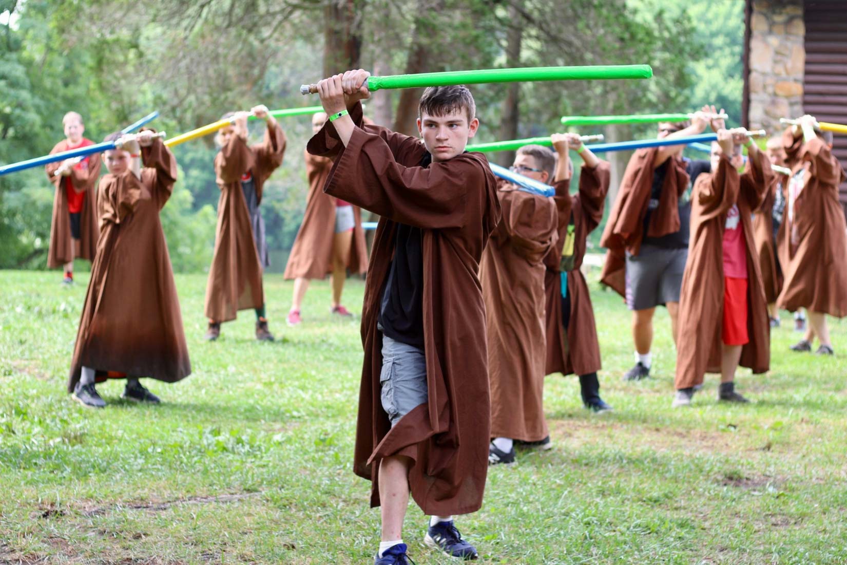 Campers holding light sabers