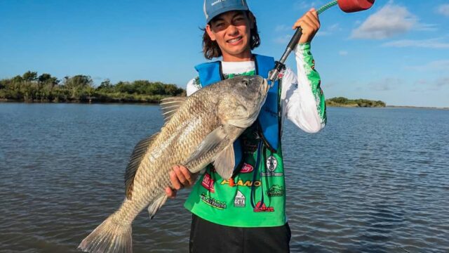 Boy holding large fish