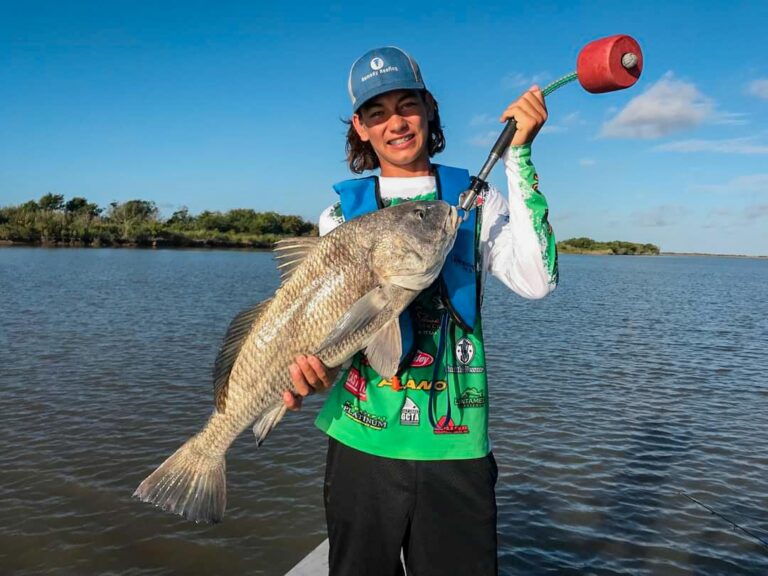 Boy holding large fish