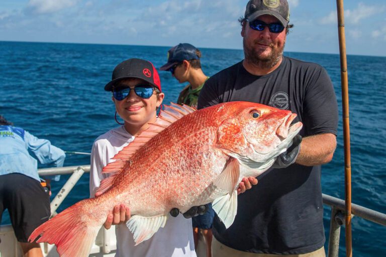 Boy holding giant fish