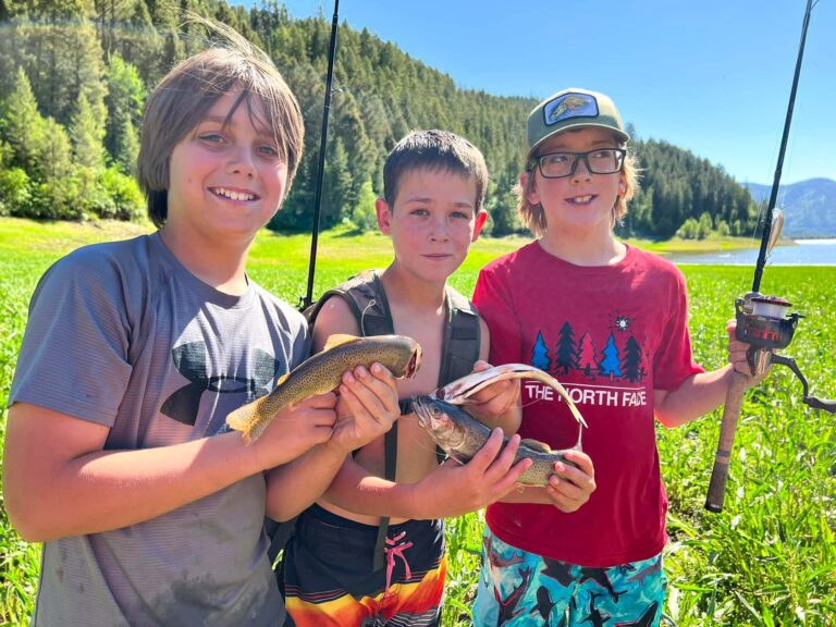 Happy boys holding fish