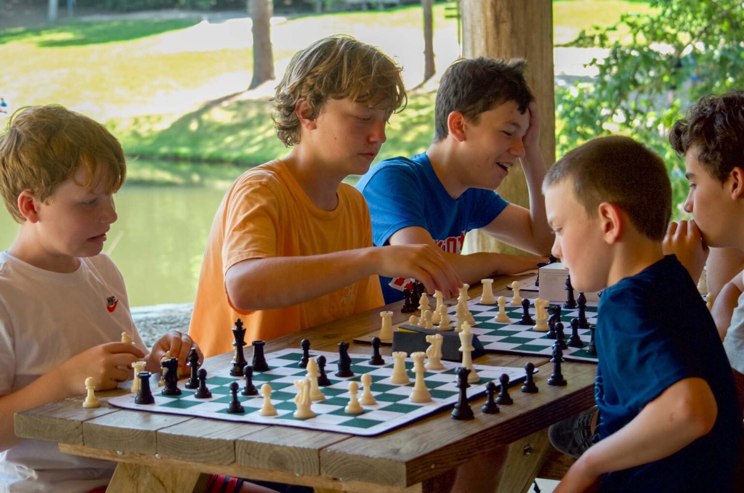 Boys playing chess at camp